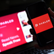 Stock image of Parler on phone and laptop